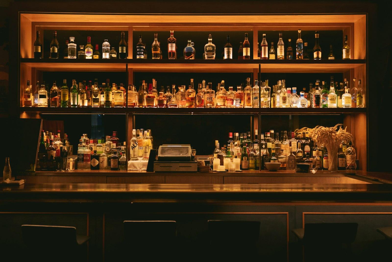 Back bar shelves stocked with spirits bottles