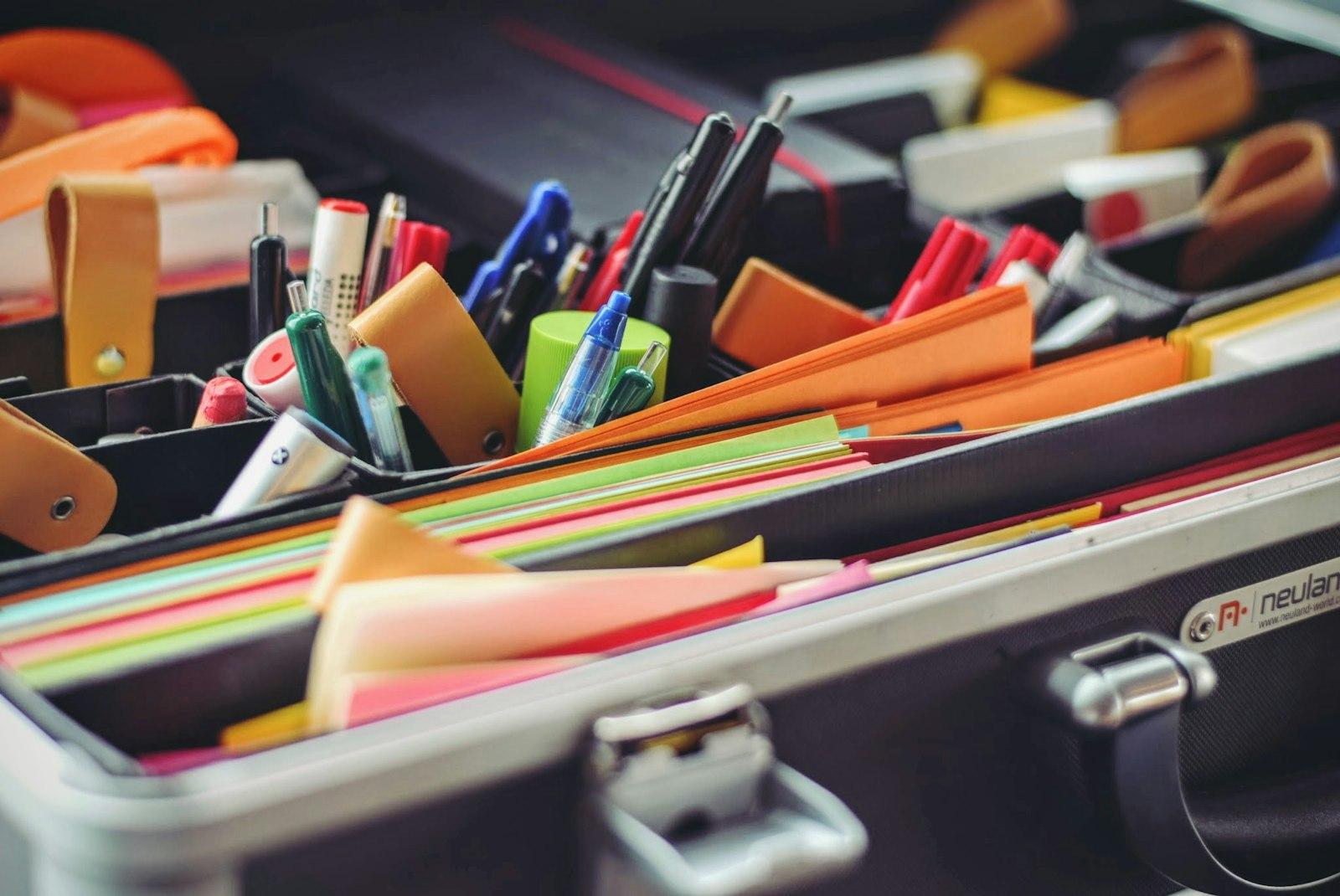 Pens, markers and coloured stationery packed in an open case