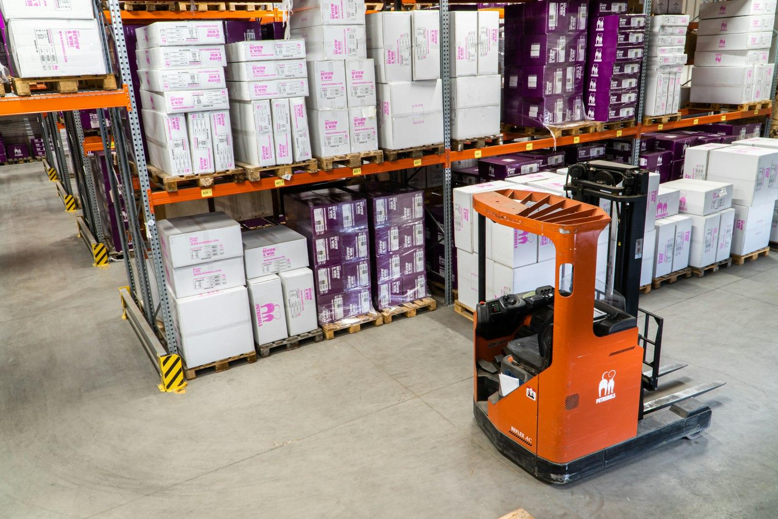 Reach truck parked in a racked aisle of palletised stock