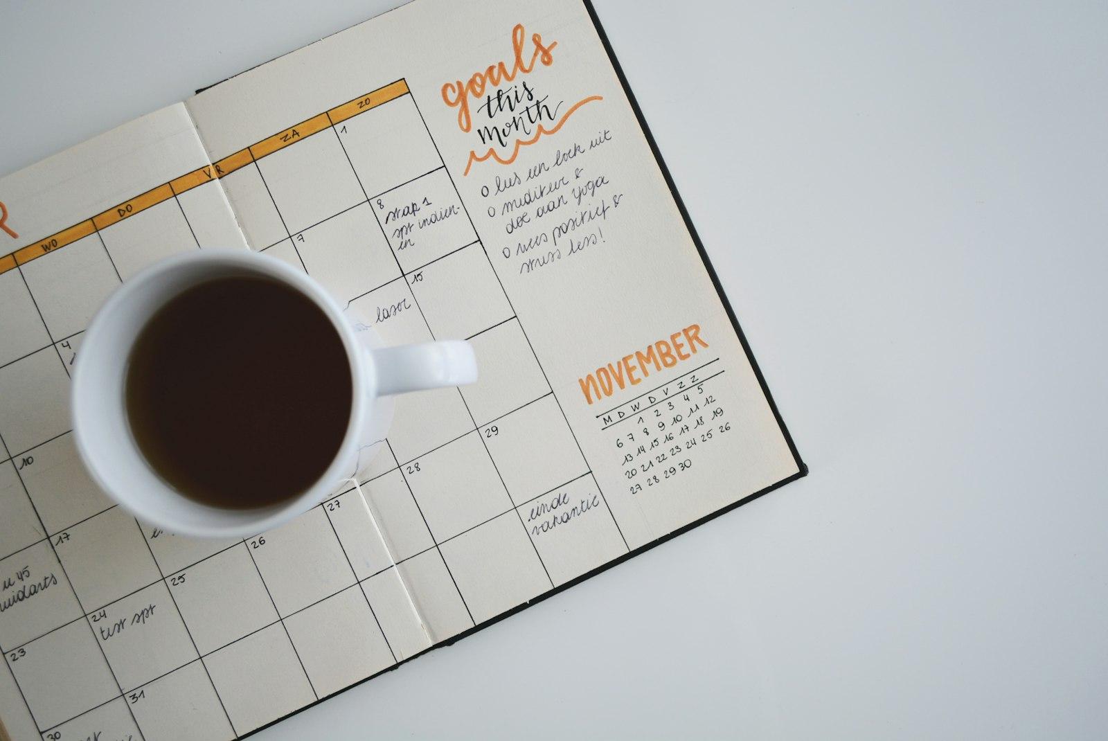 Open monthly planner on a desk used to schedule a stocktake date